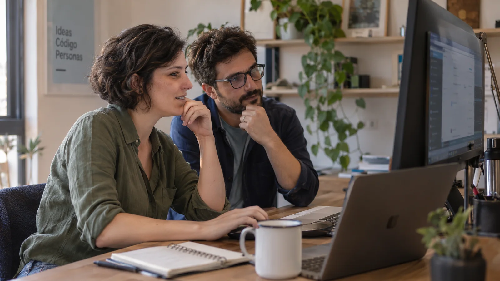 Dos desarrolladores revisando una aplicación en una oficina luminosa